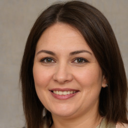 Joyful white adult female with medium  brown hair and brown eyes