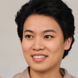 Joyful asian young-adult female with short  brown hair and brown eyes