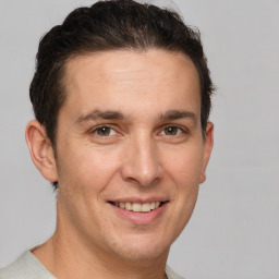 Joyful white adult male with short  brown hair and brown eyes