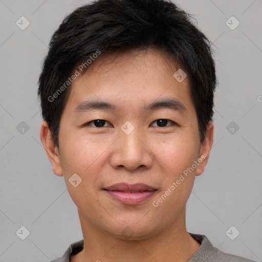 Joyful asian young-adult male with short  brown hair and brown eyes