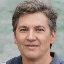 Joyful white adult male with short  brown hair and grey eyes