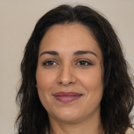 Joyful white adult female with long  brown hair and brown eyes