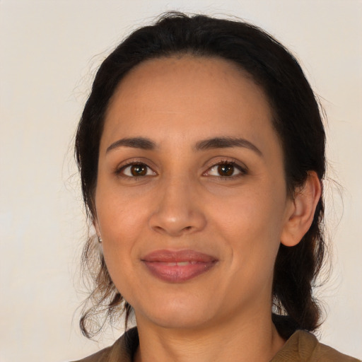 Joyful latino young-adult female with medium  black hair and brown eyes