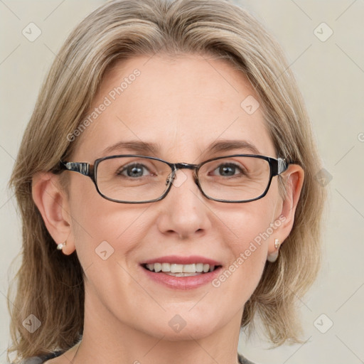 Joyful white adult female with medium  brown hair and blue eyes