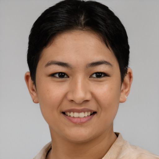 Joyful asian young-adult female with short  brown hair and brown eyes