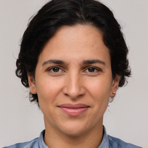 Joyful white adult female with medium  brown hair and brown eyes