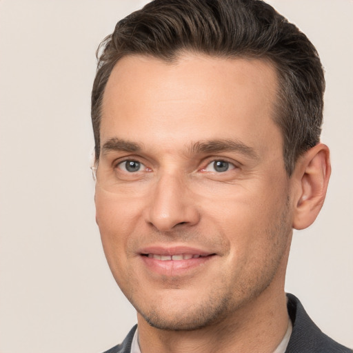 Joyful white adult male with short  brown hair and brown eyes