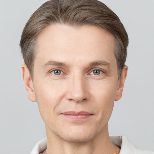 Joyful white adult male with short  brown hair and grey eyes