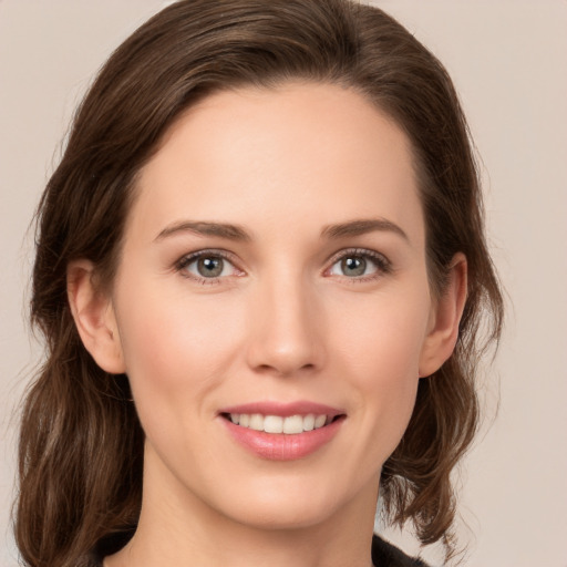 Joyful white young-adult female with medium  brown hair and green eyes