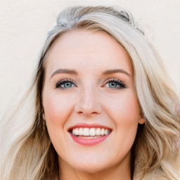 Joyful white young-adult female with long  brown hair and blue eyes