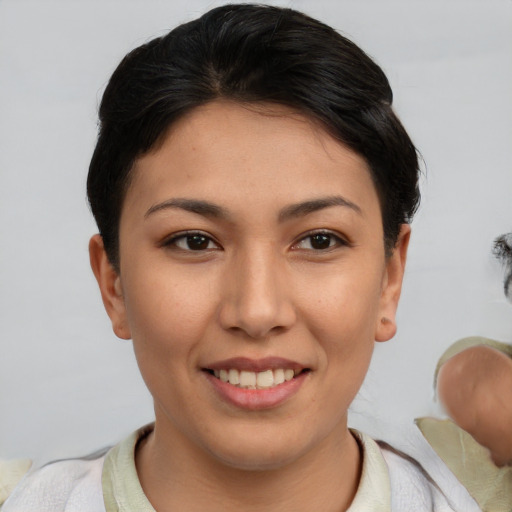 Joyful asian young-adult female with short  brown hair and brown eyes