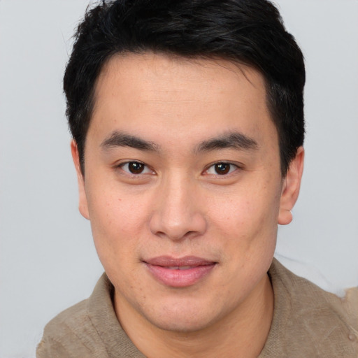 Joyful asian young-adult male with short  brown hair and brown eyes