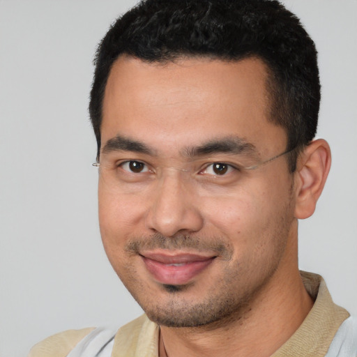 Joyful white young-adult male with short  black hair and brown eyes