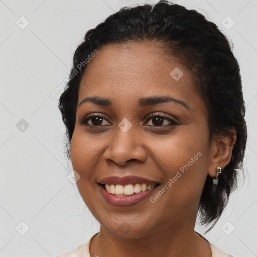 Joyful black young-adult female with medium  brown hair and brown eyes