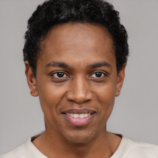 Joyful black young-adult male with short  black hair and brown eyes