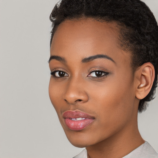 Joyful latino young-adult female with short  black hair and brown eyes