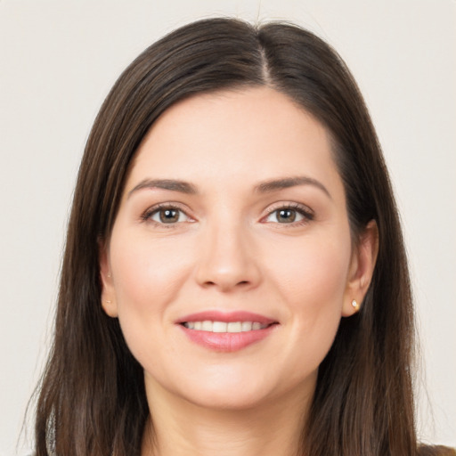 Joyful white young-adult female with long  brown hair and brown eyes