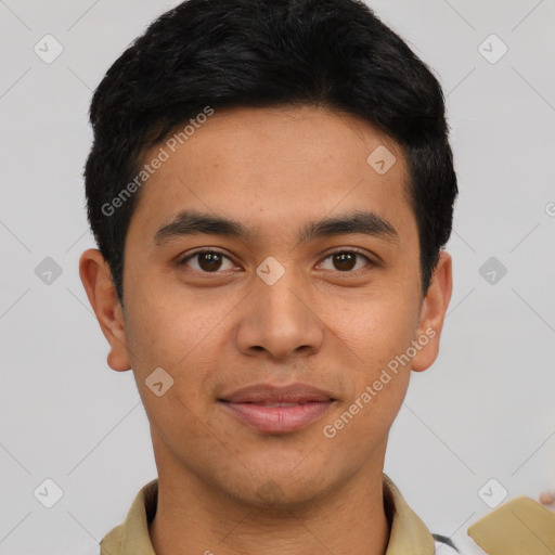 Joyful latino young-adult male with short  brown hair and brown eyes