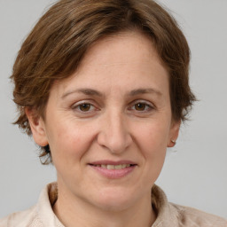 Joyful white adult female with medium  brown hair and grey eyes