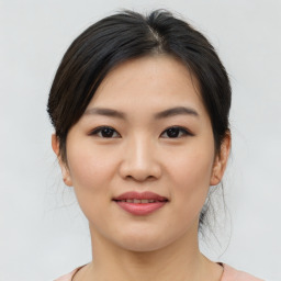 Joyful asian young-adult female with medium  brown hair and brown eyes