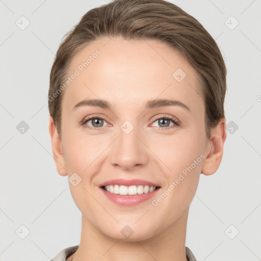 Joyful white young-adult female with short  brown hair and grey eyes