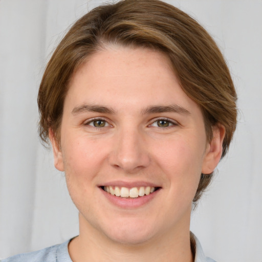 Joyful white young-adult female with medium  brown hair and green eyes