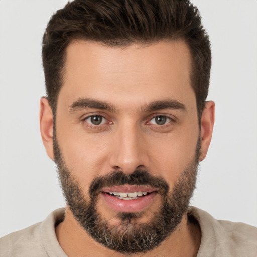 Joyful white young-adult male with short  brown hair and brown eyes