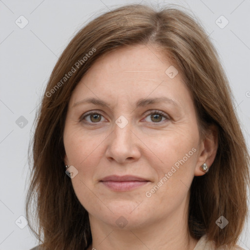 Joyful white adult female with long  brown hair and grey eyes