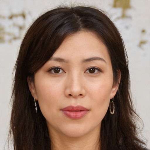 Joyful asian young-adult female with long  brown hair and brown eyes