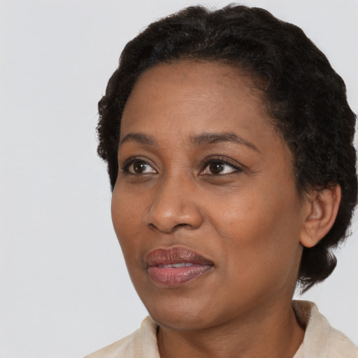 Joyful black adult female with short  brown hair and brown eyes