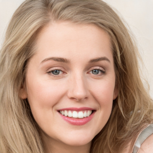 Joyful white young-adult female with long  brown hair and blue eyes