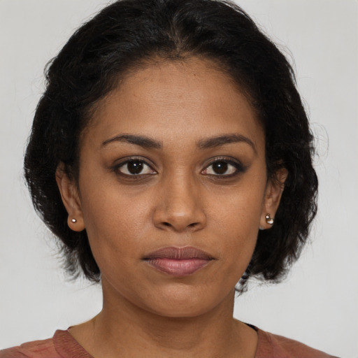 Neutral black young-adult female with medium  brown hair and brown eyes
