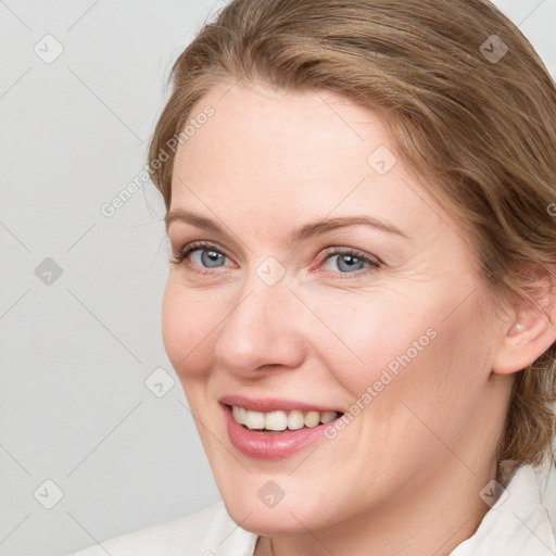 Joyful white young-adult female with medium  brown hair and blue eyes