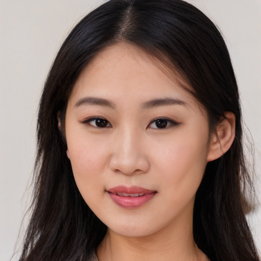 Joyful asian young-adult female with long  brown hair and brown eyes