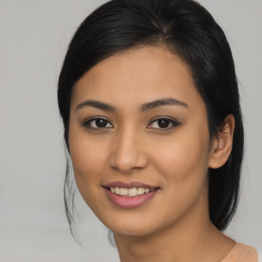 Joyful asian young-adult female with medium  brown hair and brown eyes