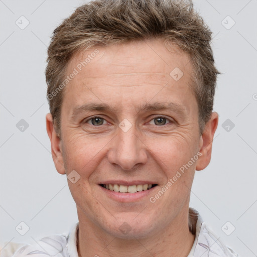 Joyful white adult male with short  brown hair and grey eyes