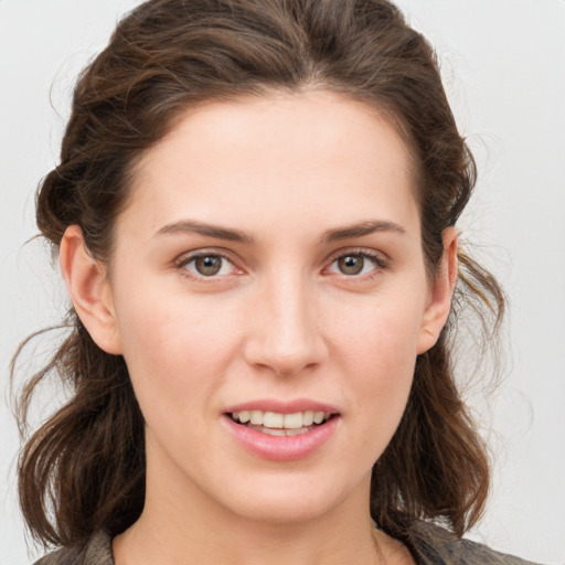 Joyful white young-adult female with medium  brown hair and grey eyes