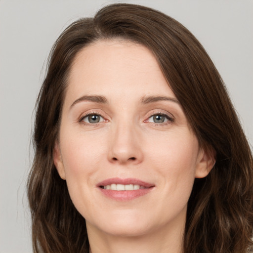 Joyful white young-adult female with medium  brown hair and green eyes