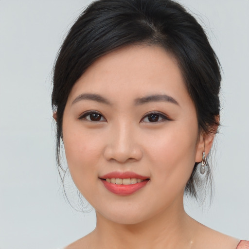 Joyful asian young-adult female with medium  brown hair and brown eyes