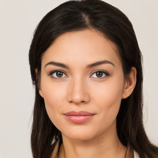 Joyful white young-adult female with long  brown hair and brown eyes