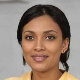 Joyful latino young-adult female with medium  black hair and brown eyes