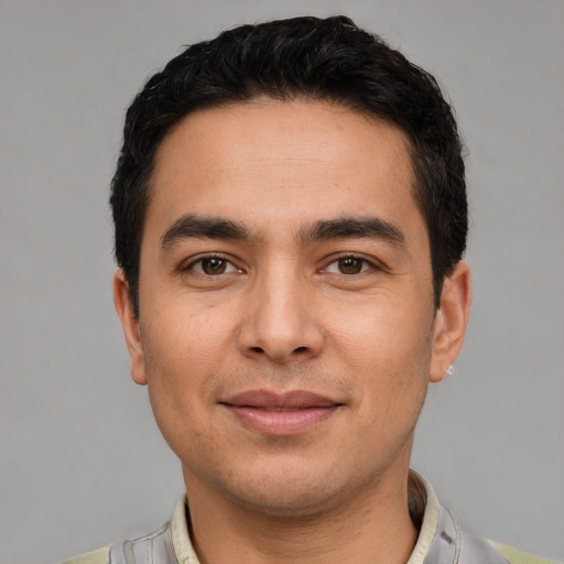 Joyful white young-adult male with short  black hair and brown eyes