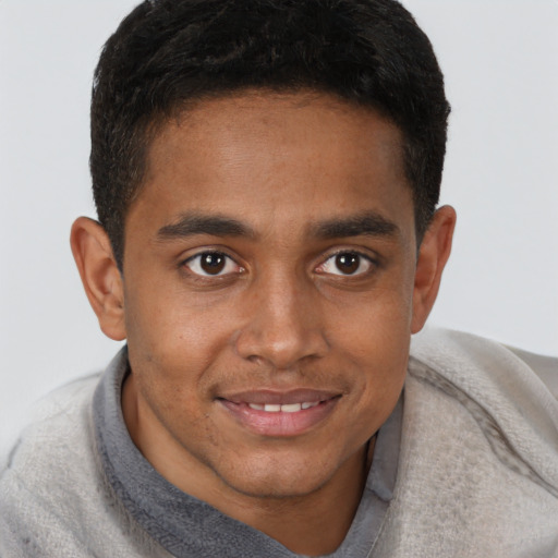 Joyful black young-adult male with short  brown hair and brown eyes