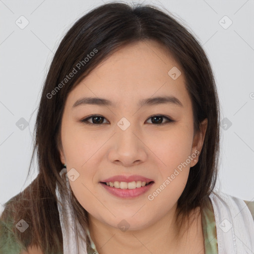 Joyful asian young-adult female with long  brown hair and brown eyes