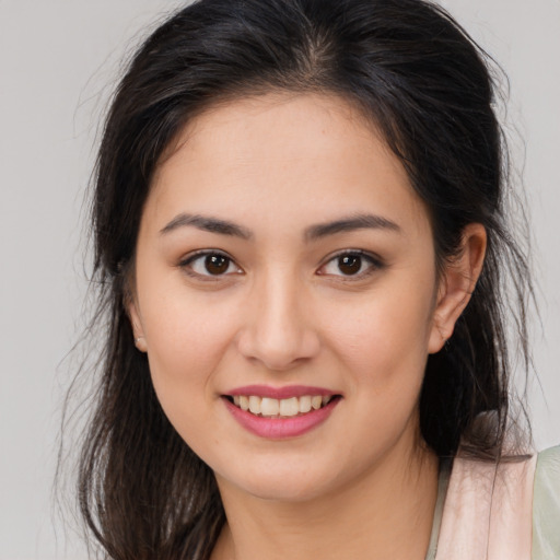 Joyful asian young-adult female with long  brown hair and brown eyes