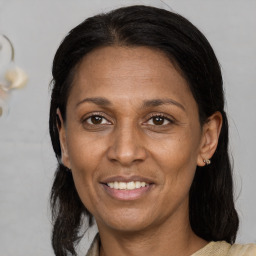 Joyful black adult female with medium  brown hair and brown eyes