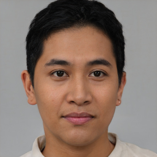 Joyful asian young-adult male with short  brown hair and brown eyes