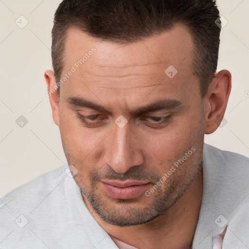 Joyful white adult male with short  brown hair and brown eyes