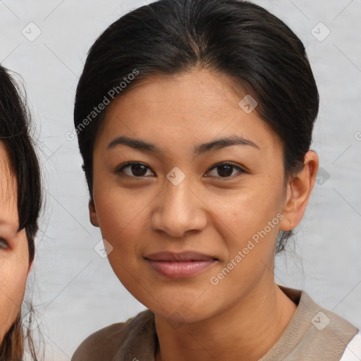 Joyful latino young-adult female with medium  brown hair and brown eyes