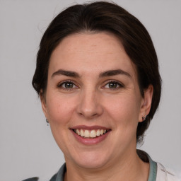 Joyful white adult female with medium  brown hair and grey eyes